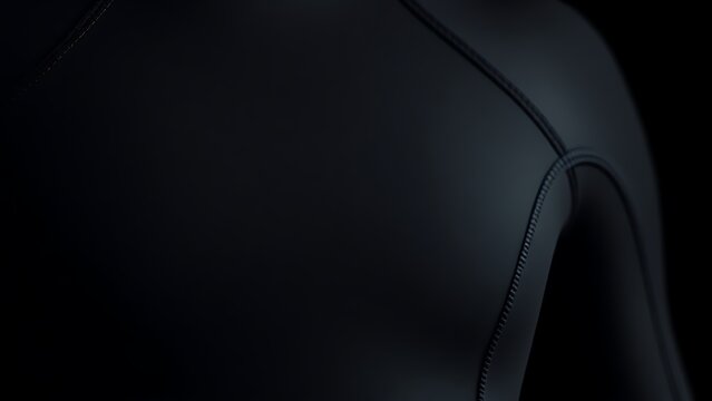 Close-up detail of a black wetsuit showing smooth rubber texture and stitching.