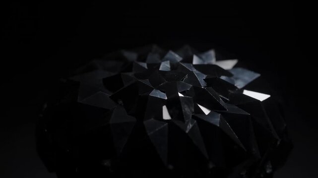 Abstract 3D geometric shards with reflective surfaces floating and scattered against a dark black background, creating a modern dynamic composition.