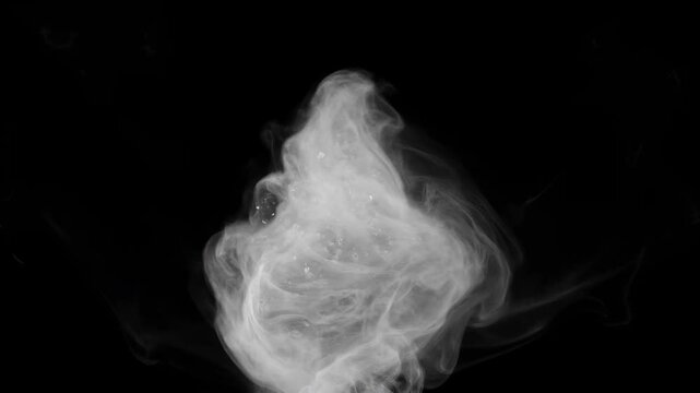 Abstract white smoke dispersing and swirling dramatically against a pure black background, creating flowing ethereal patterns and movement.