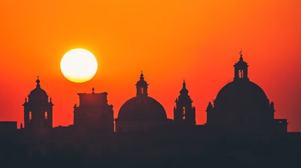 Fototapeta premium Silhouetted Churches at Sunset: A Vibrant Panorama of Maltese Architecture