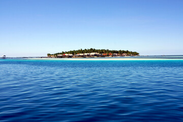 Fototapeta premium tropical island with blue sky and sea, big tarupa island, Indonesia