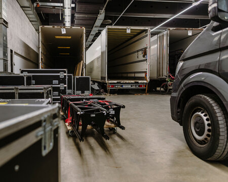 Professional Touring Equipment Cases on Loading Ramp During Event Logistics Setup in Industrial Warehouse Environment