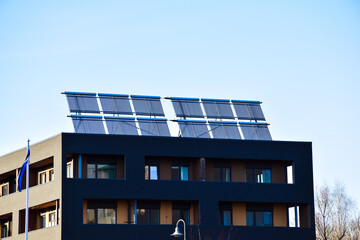 Fototapeta premium Solar vacuum tube collectors on the rooftop of a modern apartment building