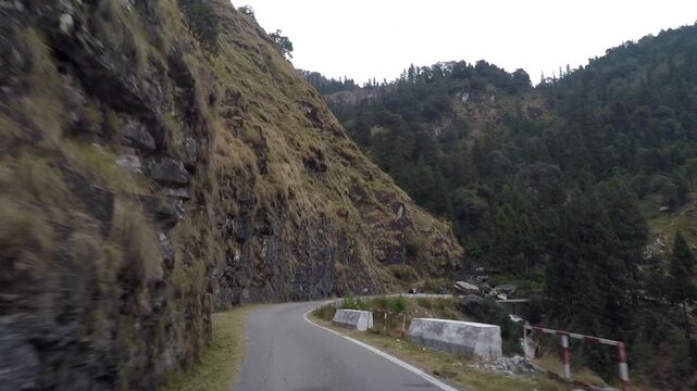 Scenic Mountain Road Through Himalayan Forest Valley with Curving Cliffside Drive
