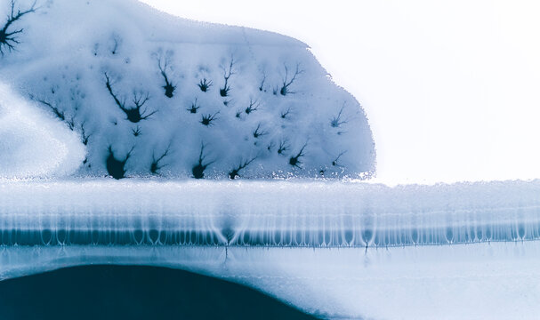 Abstract nature background of frozen lake with ice patterns, winter landscape, copy space, Fusine lakes, Tarvisio, Friuli, Italy.