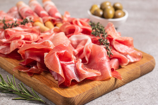 Charcuterie board. Antipasti appetizers of meat platter with salami, prosciutto crudo or jamon and olives.