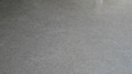 Fototapeta premium Smooth, textured concrete floor surface with subtle variations in tone and light reflections