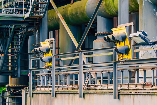 Industrial factory complex rusted ladders heavy machinery architecture wallpaper background