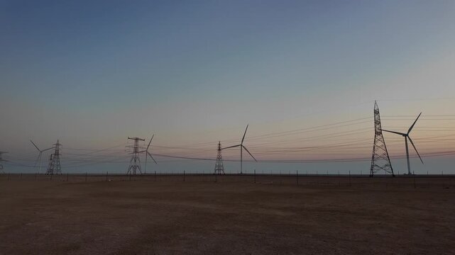 Wind turbines rise along the Saudi&ndash;UAE road, converting wind into energy and inspiring a vision of sustainable progress.