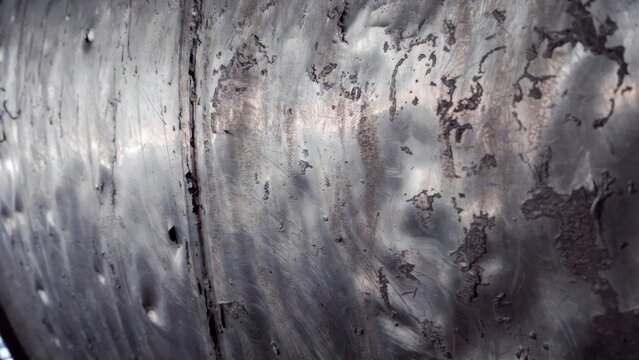 Abstract metallic texture background with peeling paint, rust spots, and dents