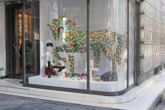 TOKYO, JAPAN - November 23, 2018: Detail of Maison Hermes Ginza including a window display.
