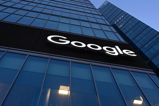 Warsaw, Poland, Europe - 04.2026 : Google logo, The Warsaw HUB complex of office skyskrapers, shopping center and hotel building with Crowne Plaza and Holiday Inn, complex sold to Google in 2022