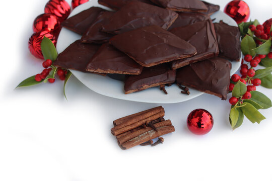 Italian traditional festive cookies called Mostaccioli or Mustaccioli on white background with copy space. Christmas cookies made mith Pisto, a mix of various spices 