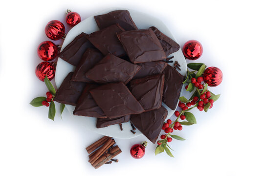 Italian traditional festive cookies called Mostaccioli or Mustaccioli on white background with copy space. Christmas cookies made mith Pisto, a mix of various spices 