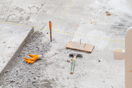 Construction tools lying on the ground at a worksite The Concept of manual labor
