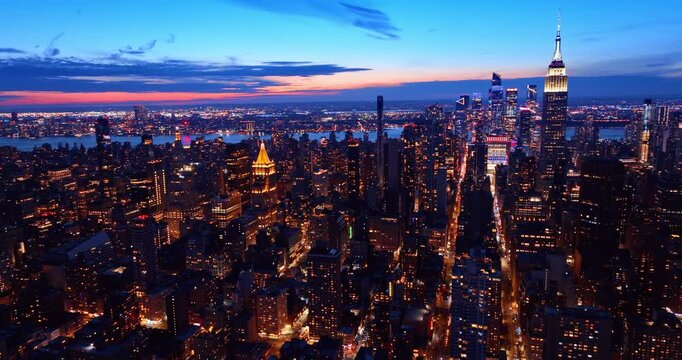 Luminous streets crossing Manhattan cityscape at night. Slow flight over gorgeous New York, USA by drone.