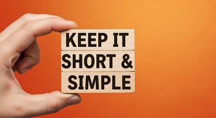 Obraz premium Hand holding sign saying keep it short and simple