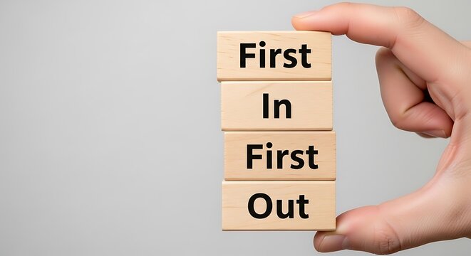 Hand holding first in first out wooden blocks