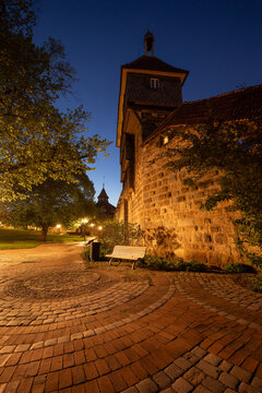 Illuminated castle fortification with Dicke Turm (Pirus communis) at dawn. Street lamps lighting the medieval site. Esslingen am Neckar, Baden-Wuerttemberg, Germany.