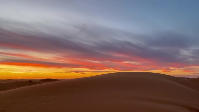 Romantic colorful sunset over the sand dunes in Sahara desert