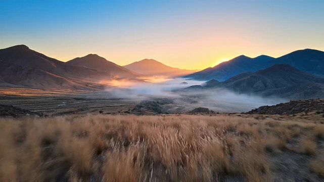 Peaceful Desert Valley at Dawn with Morning Fog and Golden Sunrise Light
