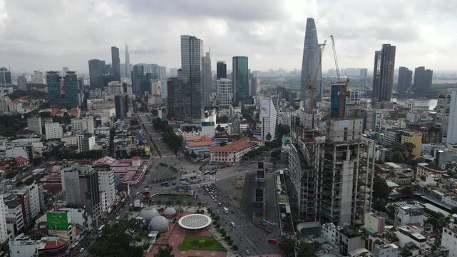 Aerial view of the modern skyline featuring Bitexco Financial Tower and urban construction under an overcast sky in Ho Chi Minh City, Ho Chi Minh, Vietnam.