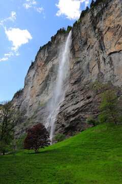 Staubbachfall waterfall in the village of Lauterbrunnen, Switzerland on a summer day.