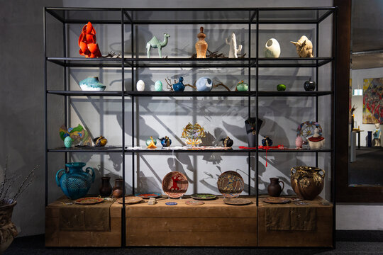 Contemporary art and ceramic collection on a multi-tiered display shelf