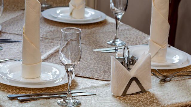 Elegant restaurant table setting with napkins and glassware