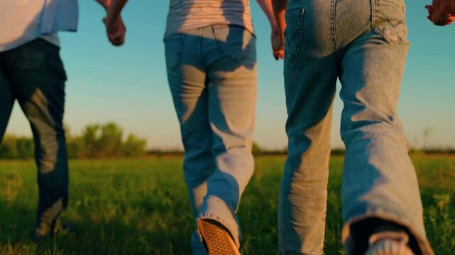 Family picnic on summer lawn. Family, mom dad, kids, weekend outdoors. Children parents run in park. Dad mom playing in park. Happy people run hand in hand together, nature. Parents raising children