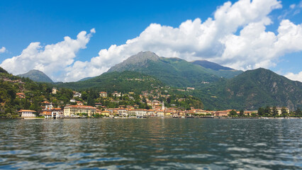 Fototapeta premium Scenic view of the waterfront in Menaggio town on Lake Como with Alpine mountains in Italy
