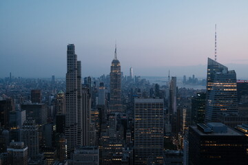 Fototapeta premium Manhattan skyline at dusk with Empire State Building, aerial cityscape, blue hour, New York City travel and urban architecture photography.