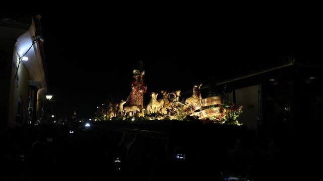 catholic procession at night in antigua guatemala (religious christian devotion display with people lit jesus float)