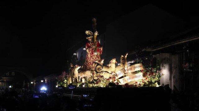 catholic procession at night in antigua guatemala (religious christian devotion display with people lit jesus float)