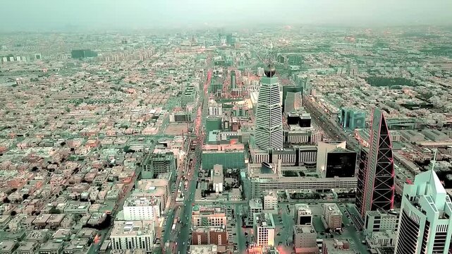 Panoramic Drone View of Riyadh City Skyline Featuring Kingdom Centre and Urban Traffic