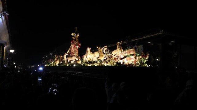 catholic procession at night in antigua guatemala (religious christian devotion display with people lit jesus float)