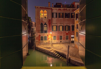 Night view of Venice canal from open window, Italy © pillerss
