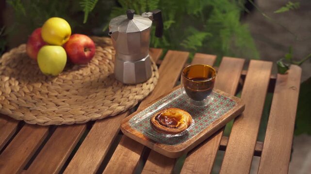 Pastel de nata on a ceramic tray on a woden table