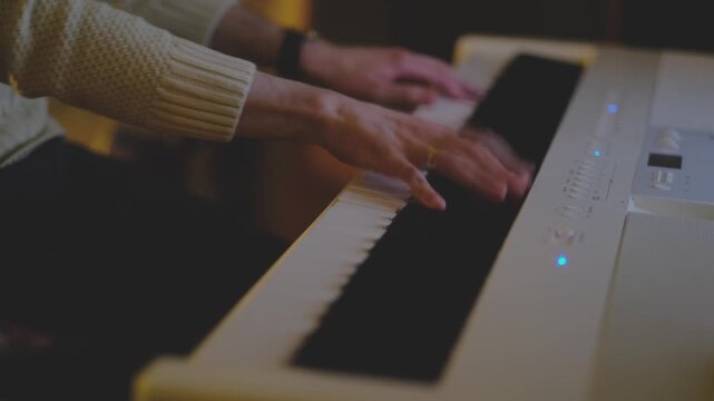 Fast moving hands playing white digital piano in warm cinematic light, energetic music performance, close up keyboard scene with dynamic motion indoors.