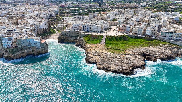 Aerial view of the rocky coast of southern Italy with the famous Lama Monachile beach in Polignano a Mare. 