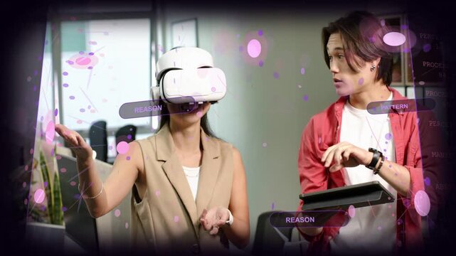 Female VR user raising hand to screen, showing overlays while man tapping tablet guiding tech demo