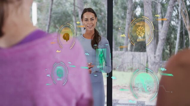 Instructor speaking, HUD icons appearing on glass showing brain DNA human, guiding wellness class