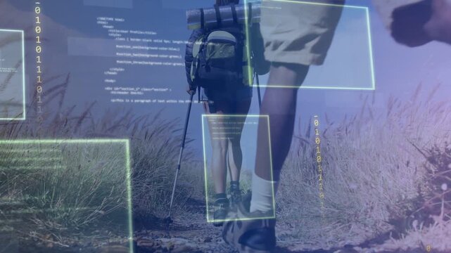 Low-angle camera tracking female hiker, male hiker joining, code aligning over boots showing tech