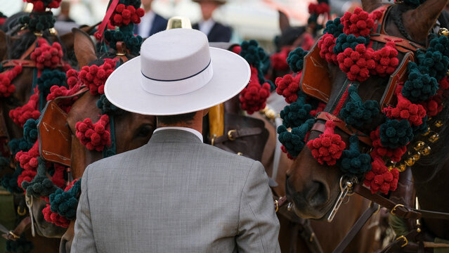 Jinete a caballo con sombrero en feria.