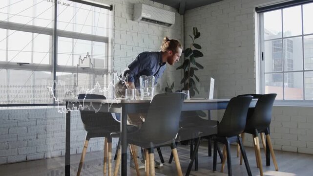 Businessman pushing back from table walking past camera inspecting laptop as chart overlay aligning