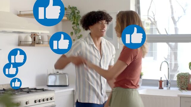 Couple hugging holding hands playful gesturing in kitchen causing blue likes filling for creators