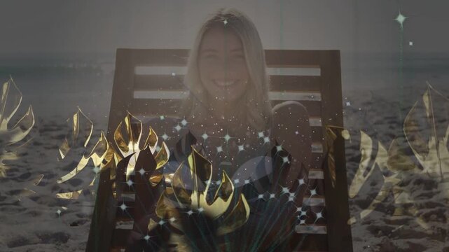 Woman reclining on sand, sequence starting, gold leaves and sparks forming crown around head for ad