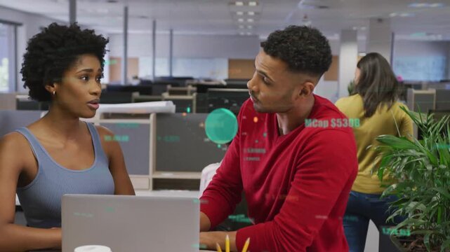 Woman pointing at laptop and explaining biz project, man leaning tapping trackpad studying teal HUD