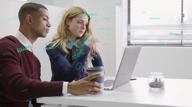 Man leaning in pointing at laptop, woman pointing and both finalizing business content, coffee cup