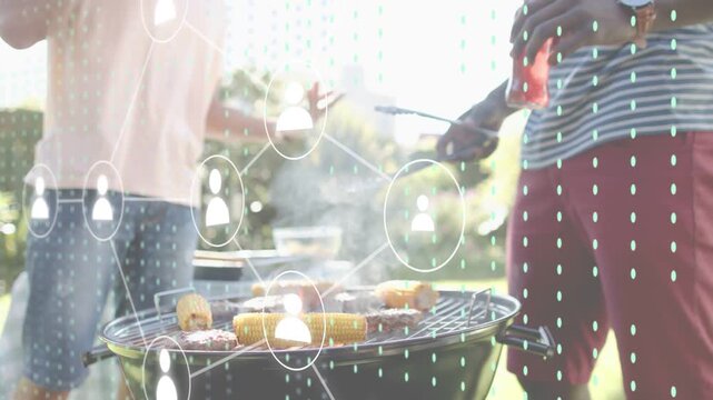 Two men tending grill as right man flipping burgers for friends, tech icons expanding over grill